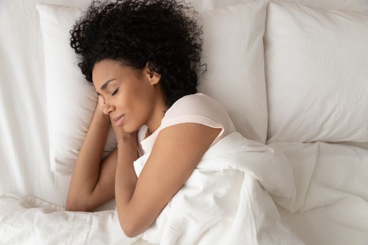 Mother relaxing in bed enjoying a peaceful moment for Mother's Day